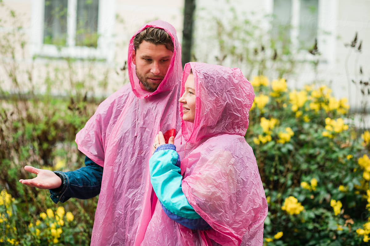 Couple in raincoat talking while walking