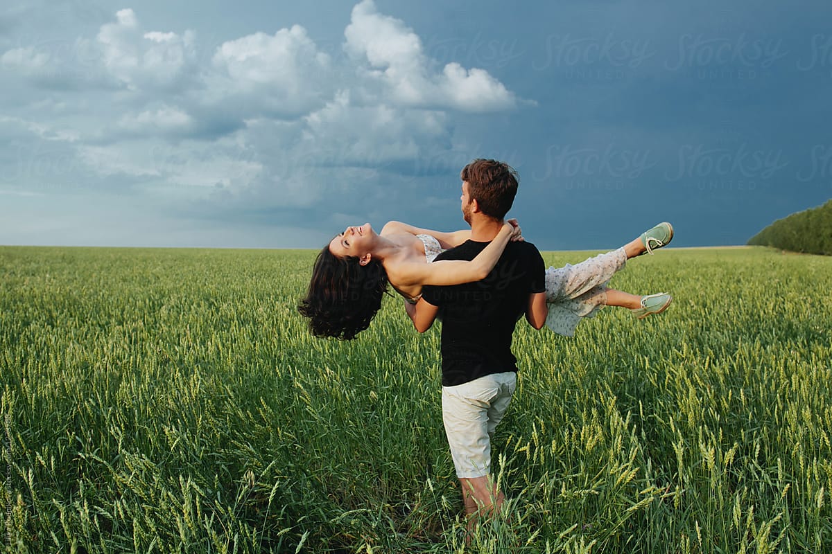 Young Happy Couple In The Field by Liliya Rodnikova