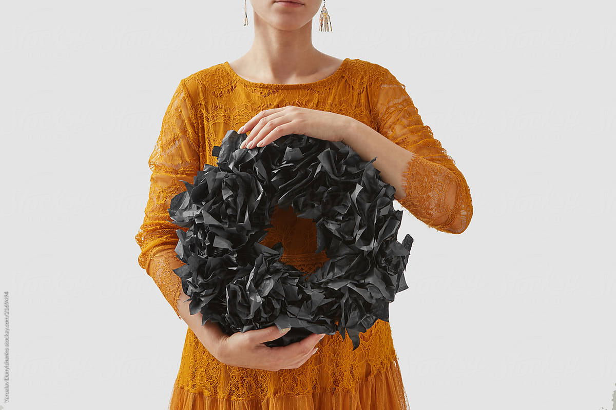 Handmade black wreath in a girl\'s hands for Halloween