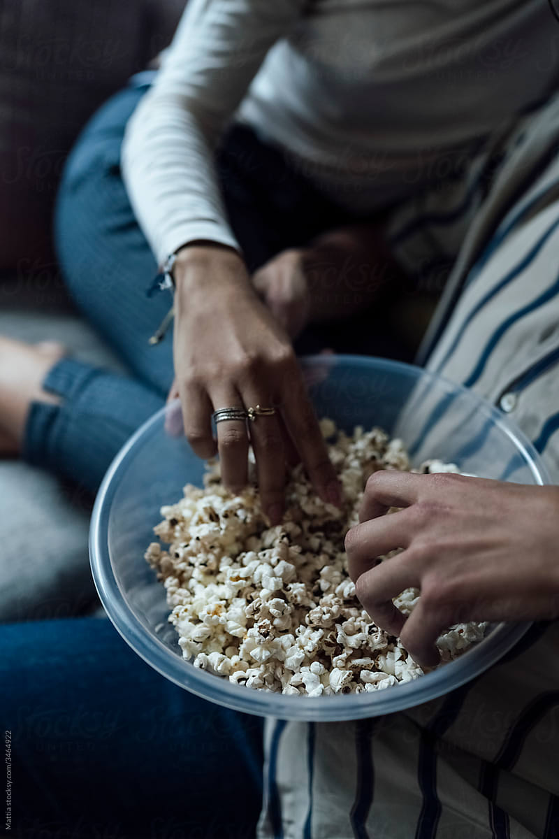 Close Up of a Black Couple Eating Popcorn at Home