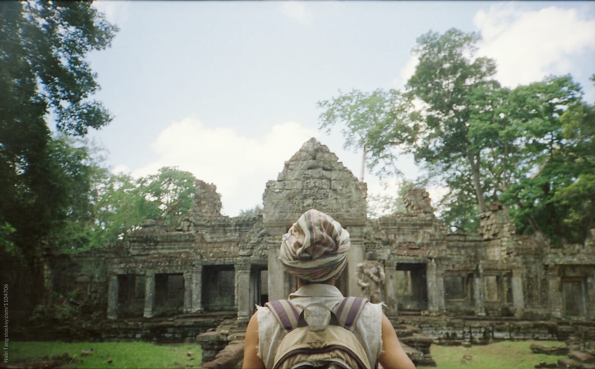 Backpacker walking around Angkor Wat temple area in Siem Reap, Cambodia
