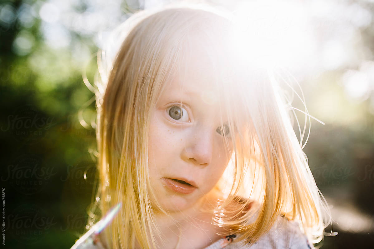 Little Girl Making Silly Wide Eyed Face With Sunflare