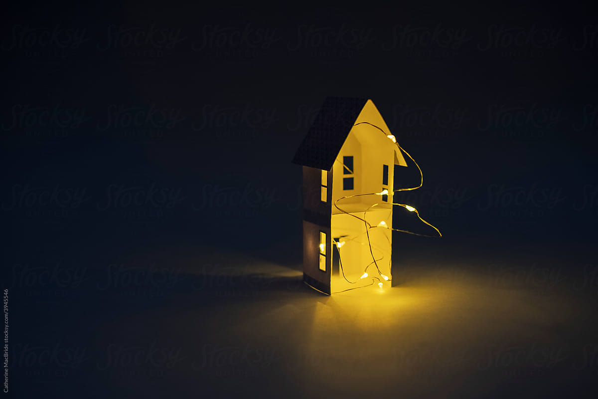 Model paper craft home lit with fairy lights in the dark
