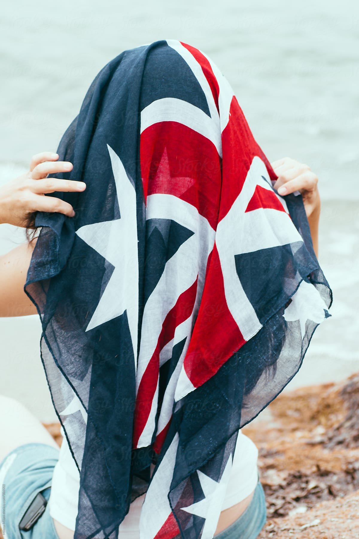 Girl covering her head with the Australian flag