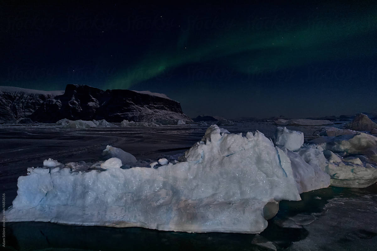 Greenland Arctic winter - aurora borealis northern lights and iceberg