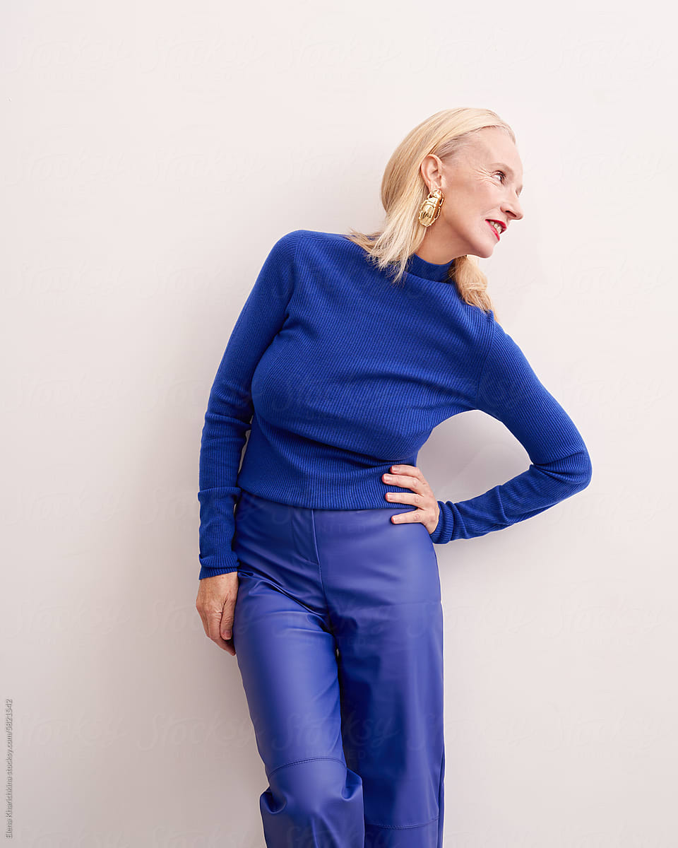 Stylish older model in a blue turtleneck with bright makeup
