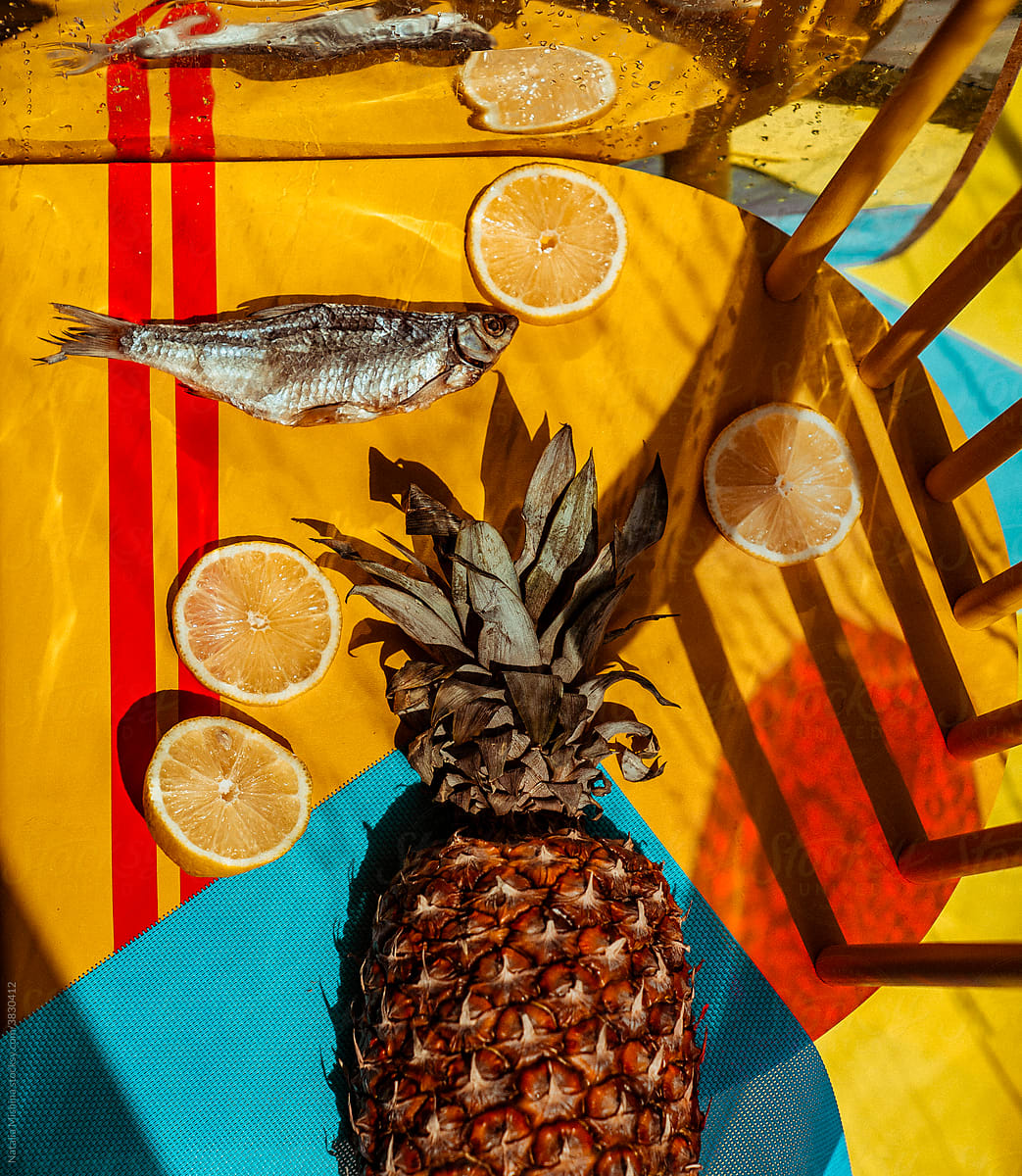 Bright stillife with fish, pineapple and lemon