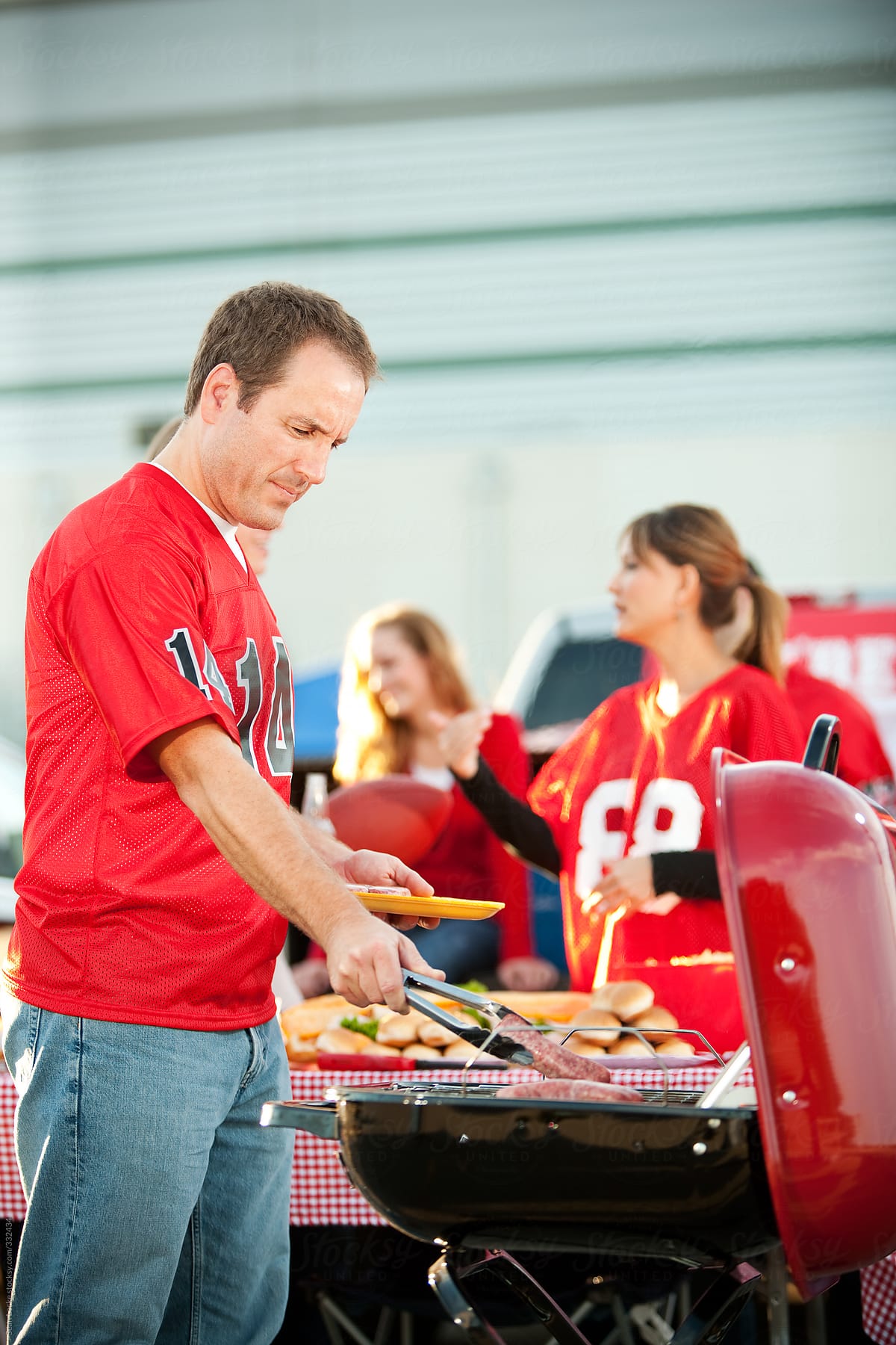 Tailgating: Man At Grill Cooking Sausages