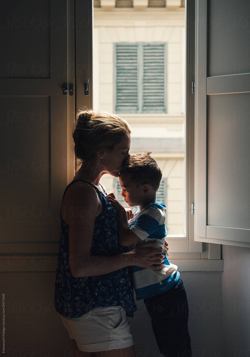 Mother and son playing by the window in their room