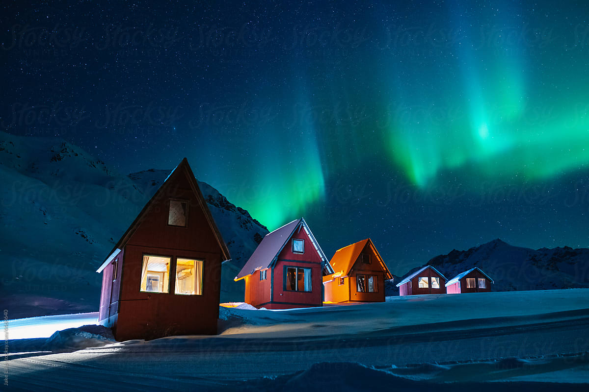 Northern Lights in Alaska\'s Mountains Over Red Cabins