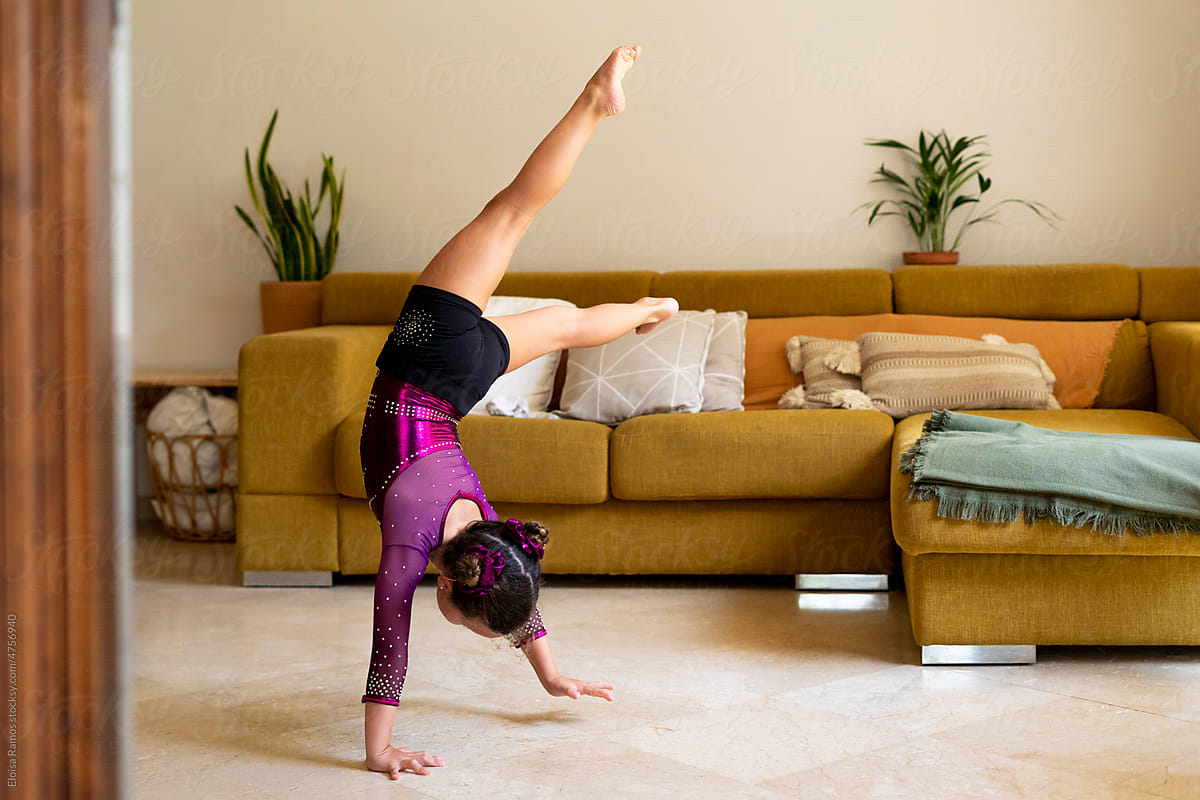 little girl practicing artistic gymnastics at home