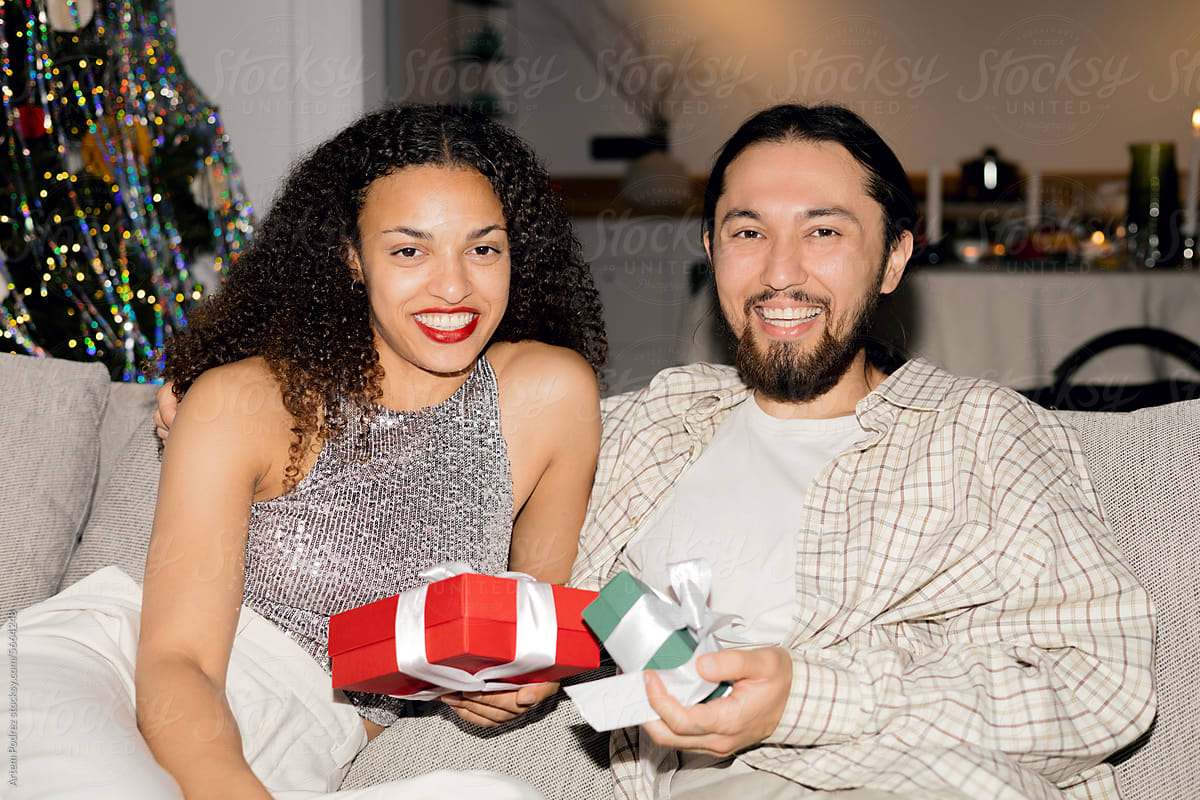 Holiday Happiness: Couple\'s Gift Exchange by the Tree