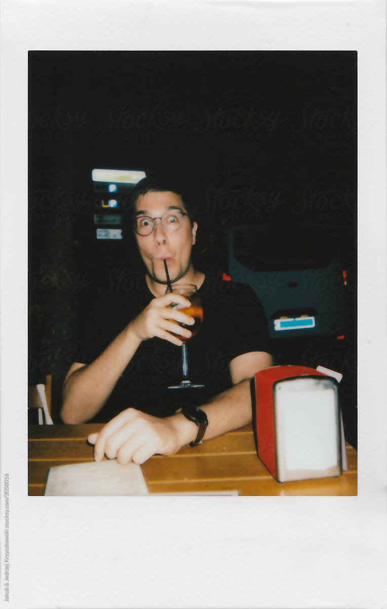 Young Fellow with Funny Face Enjoying the Aperol Drink
