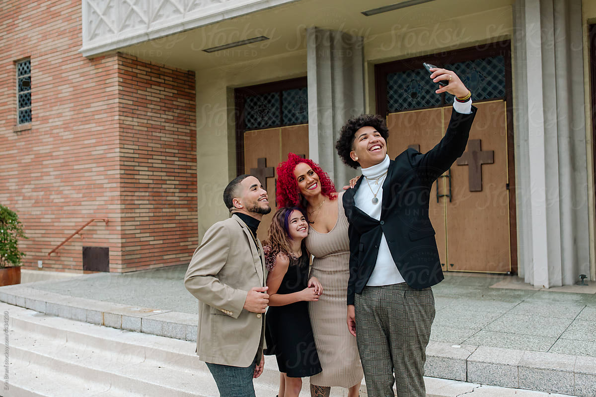 Family selfie in front of church entrance