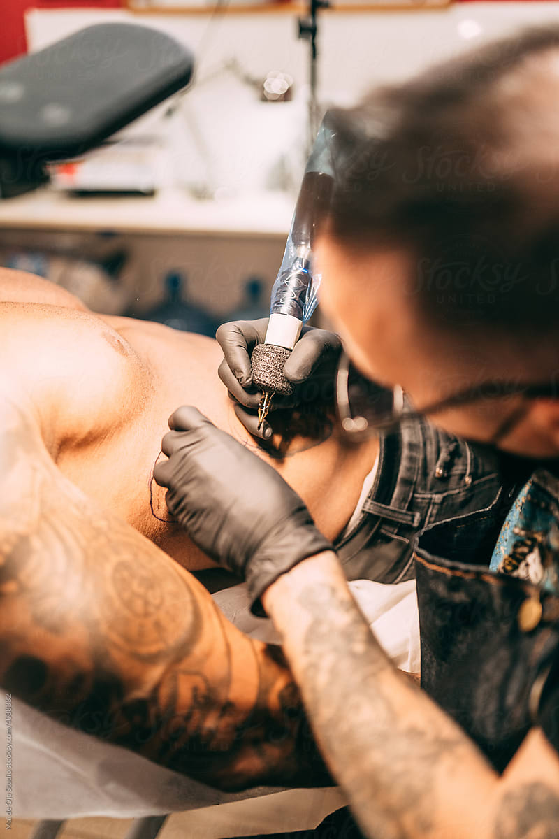 Tattoo artist working at his studio