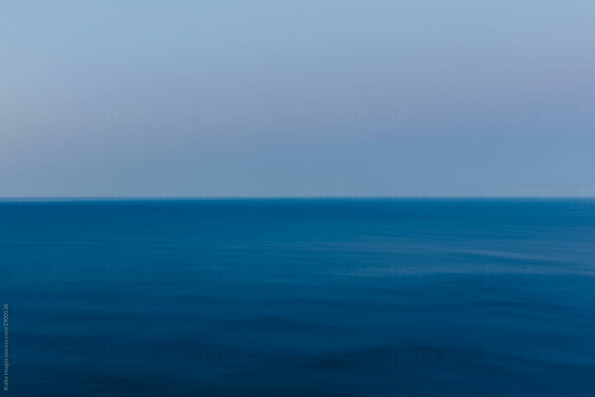 Abstract of vast blue ocean, horizon and sky at dusk
