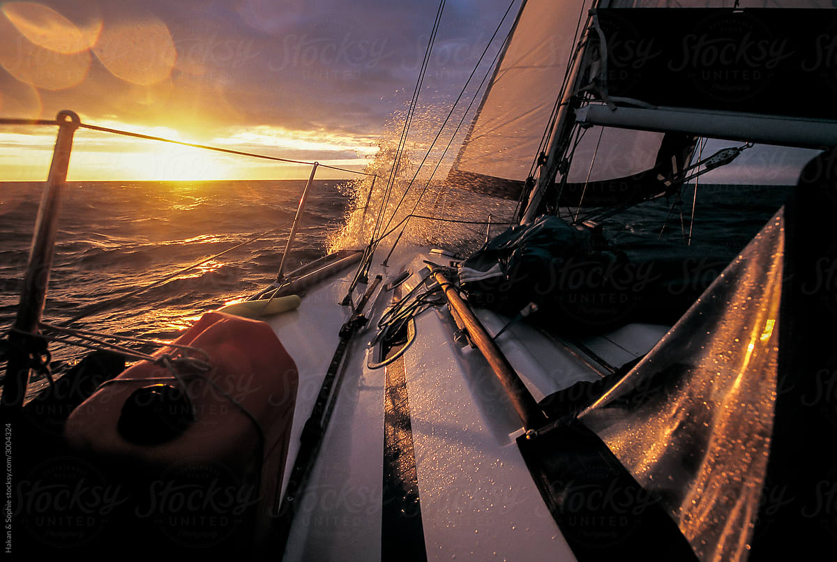 long haul sailboat sailing into the sunset