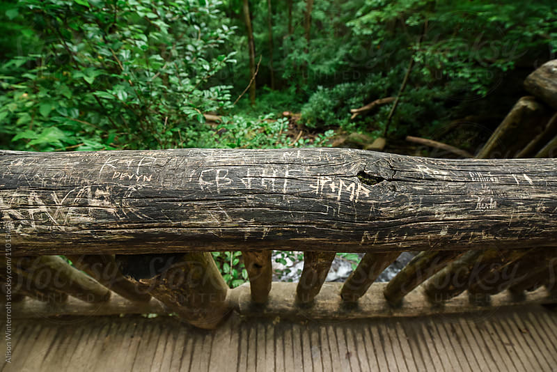 Wood Railing With Carved Words On It