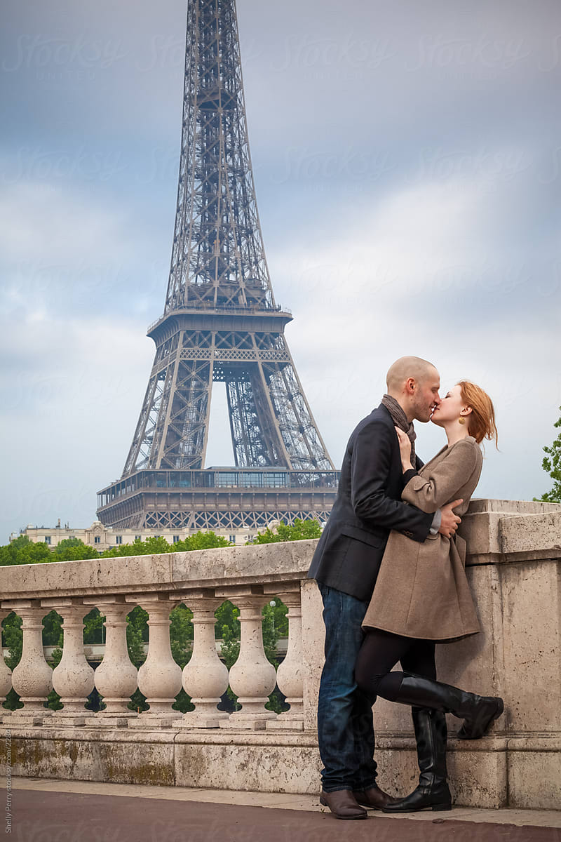 Romantic Couple In Paris Kissing, Eiffel Tower In The Background by