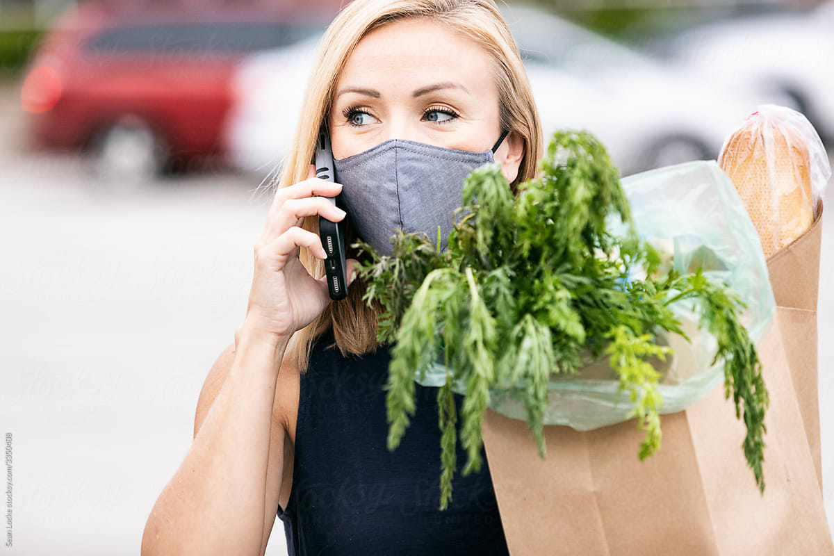 Grocery Shopper With Face Mask Talks On Cell Phone