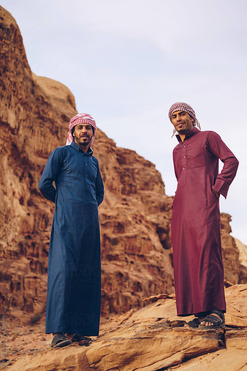 Arabic men standing in the desert looking at the camera