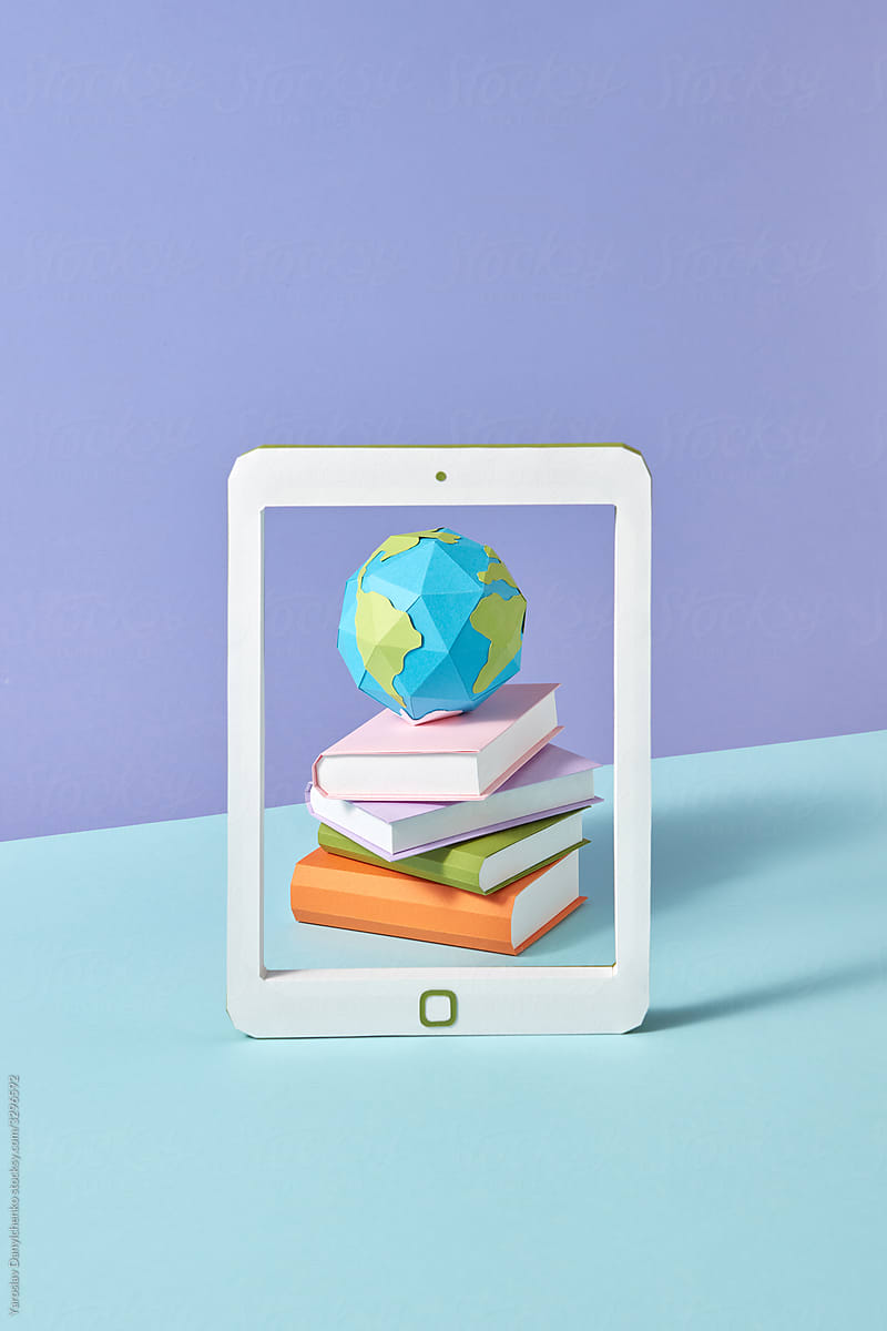 Papercraft tablet screen with books and globe.