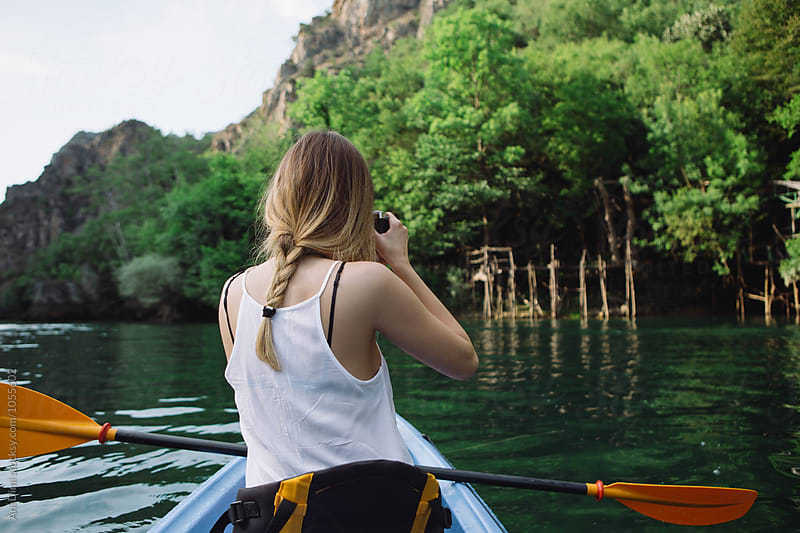 Woman kayaking and taking photo