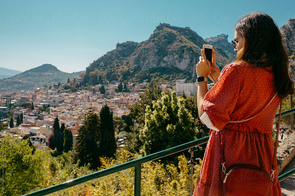 Female tourist taking a picture with smartphone of panoramic view