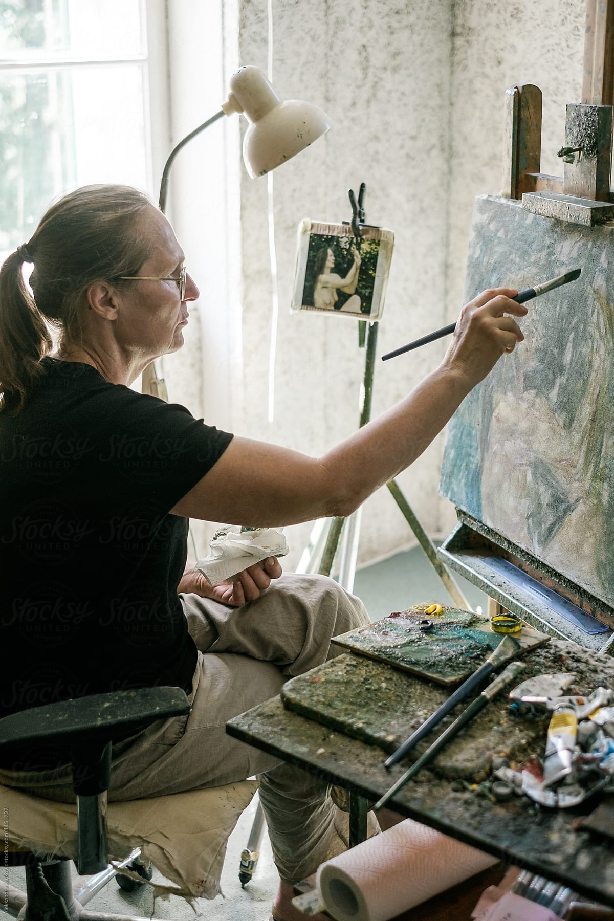 Female Artist Working On The Painting
