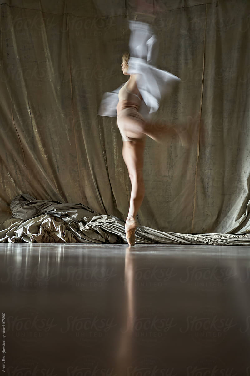 Blonde ballet dancer performing inside dance hall