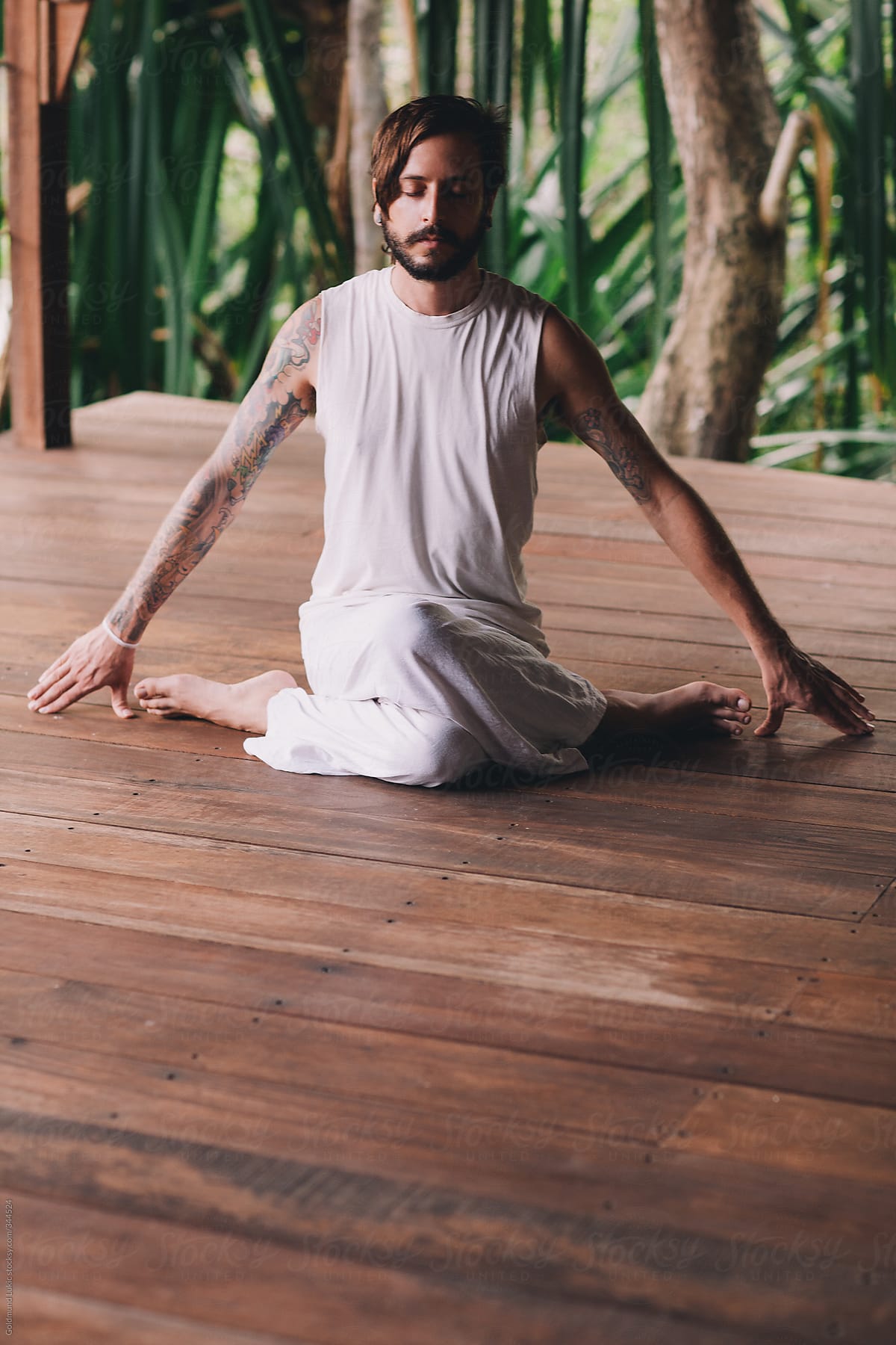 Tattooed Man Meditating in the Hero Pose (Virasana)