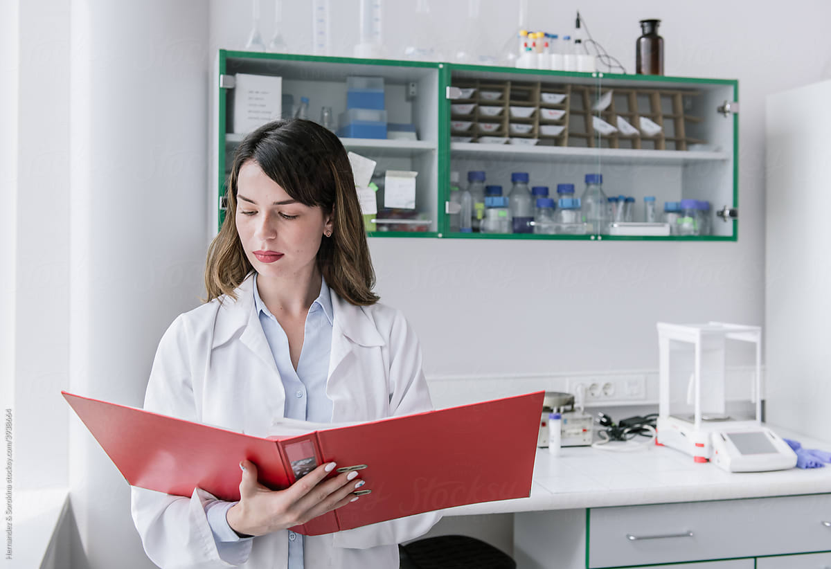 Researcher Analysing Papers In The Lab