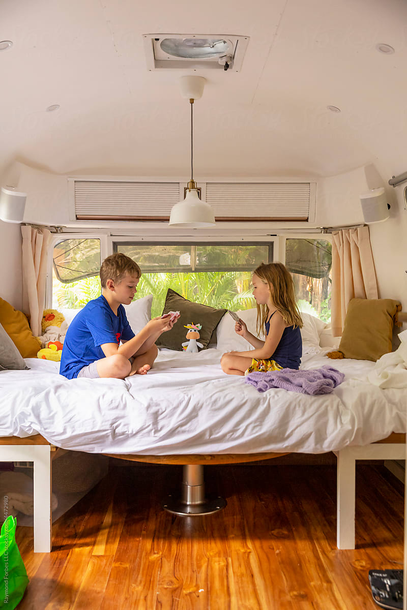 Family lifestyle in RV on Vacation with kids playing cards
