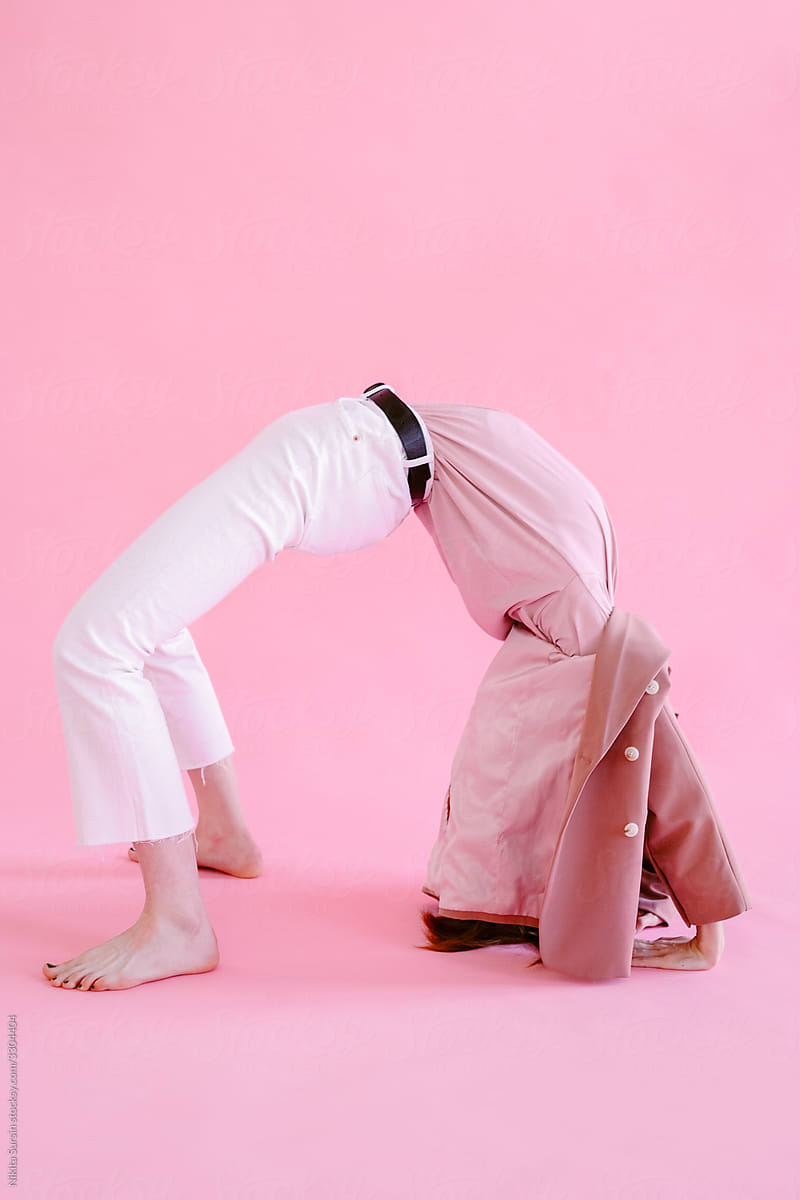 girl in pink clothes posing on a solid pink background in the studio, positive atmosphere