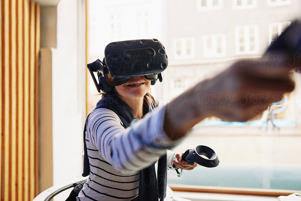 Smiling senior woman using virtual reality gear