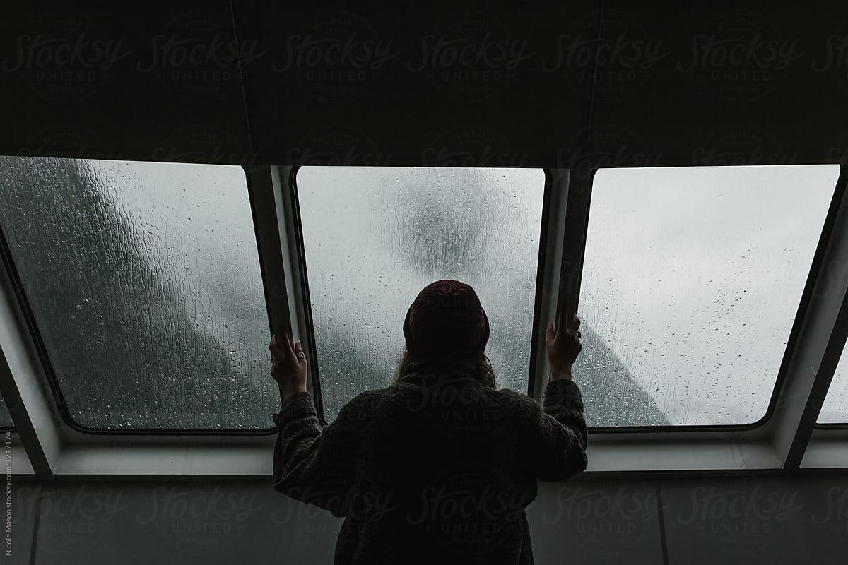 woman looking out window on ferry boat