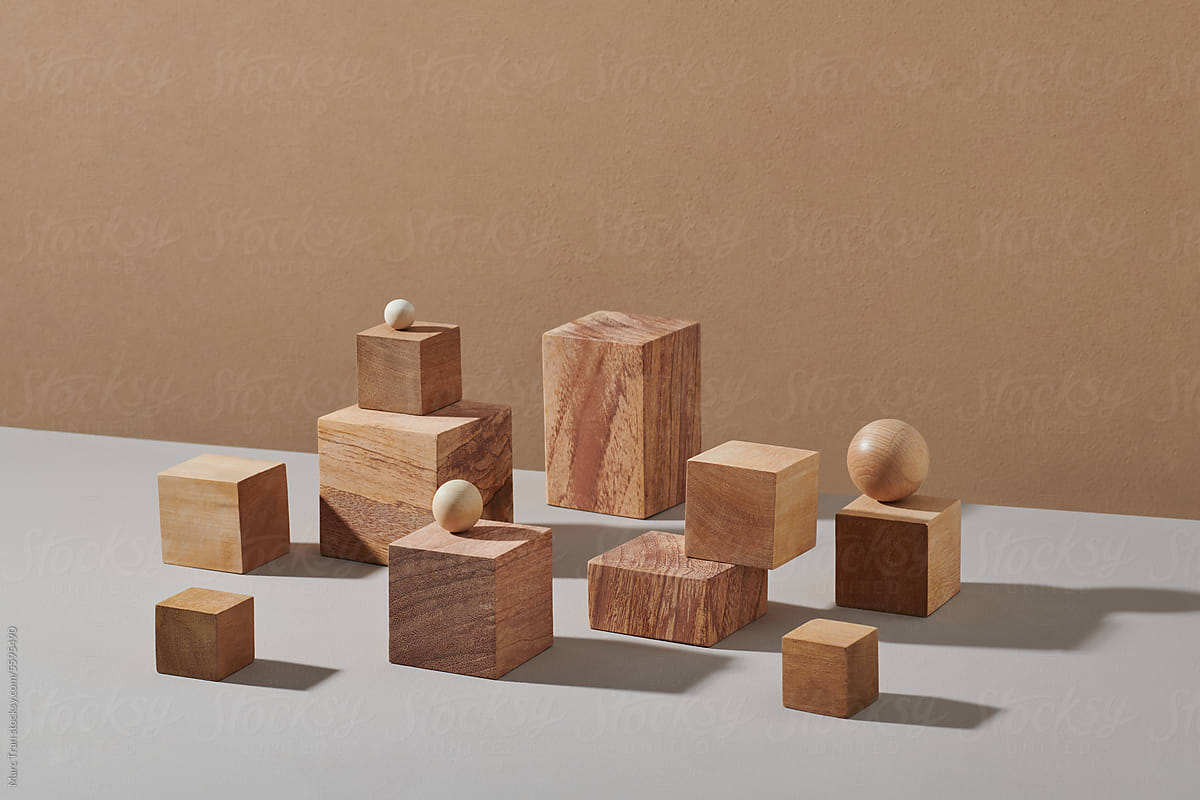 Wooden scenes of different geometric shapes on a beige background.