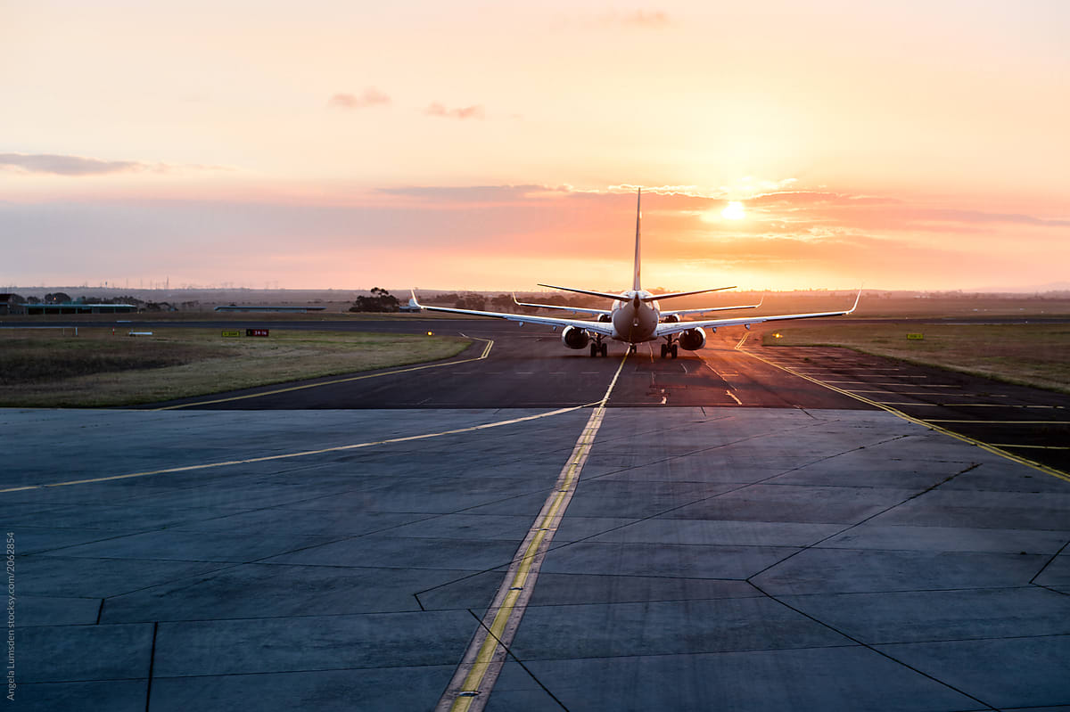 Queuing to enter the runway at an airport at sunset