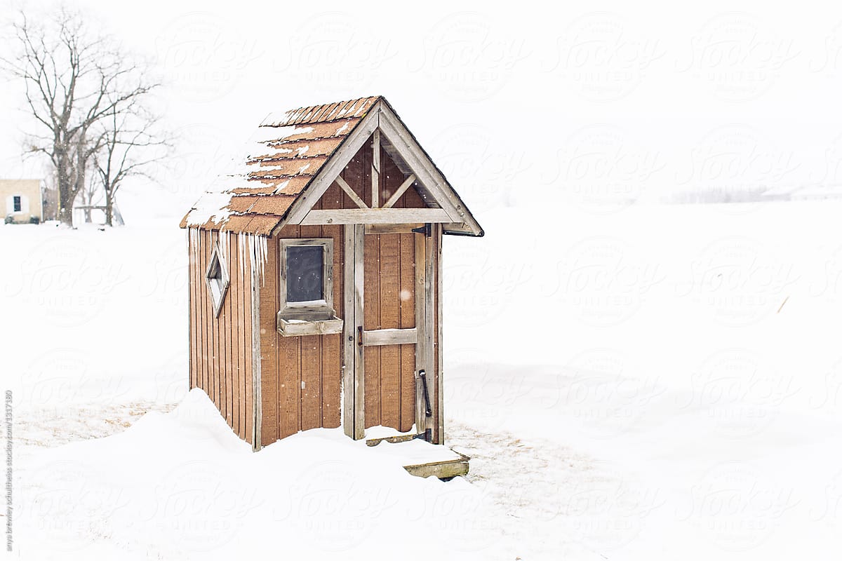 A wooden outdoor warm shed during winter