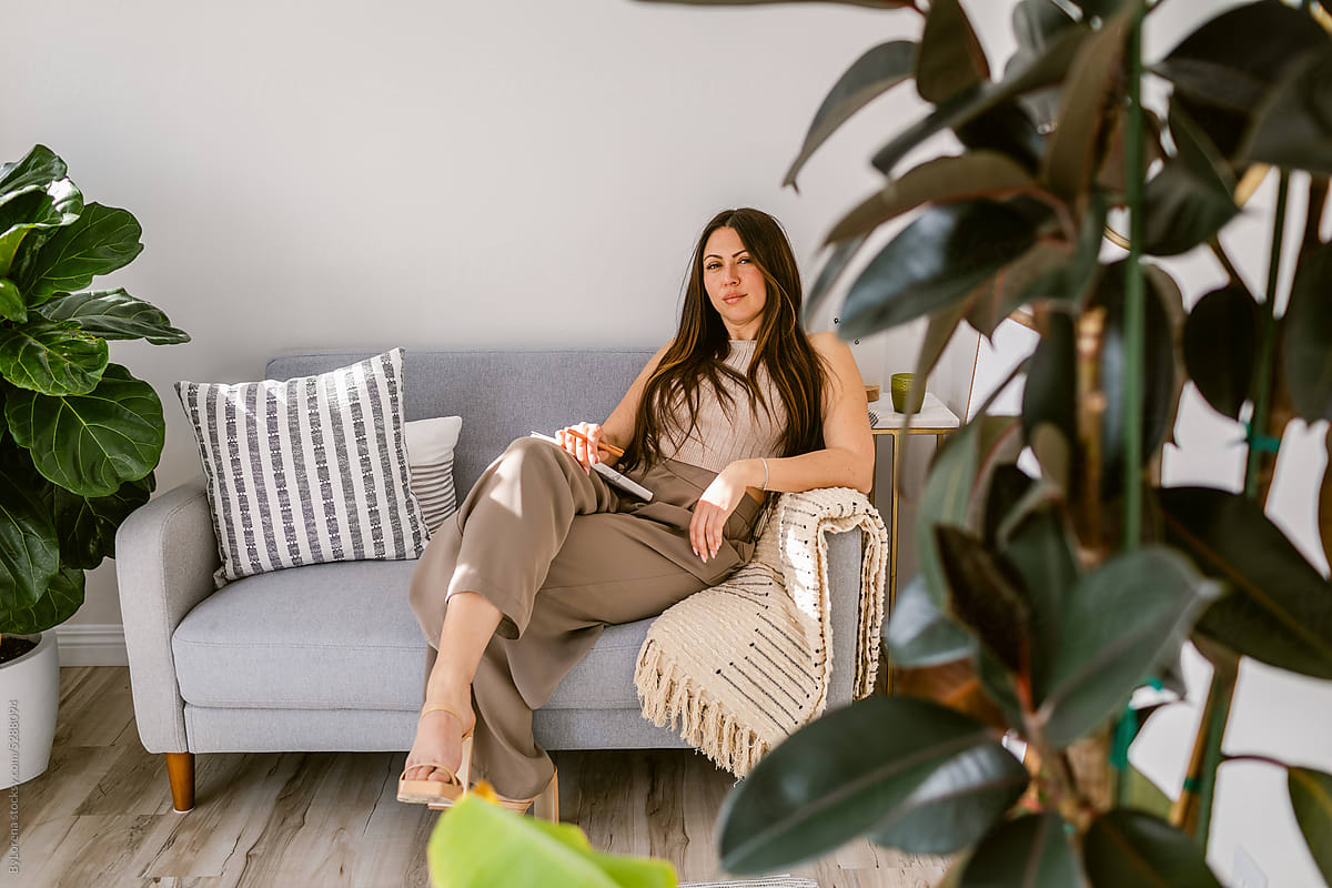 Happy elegant entrepreneur woman on couch