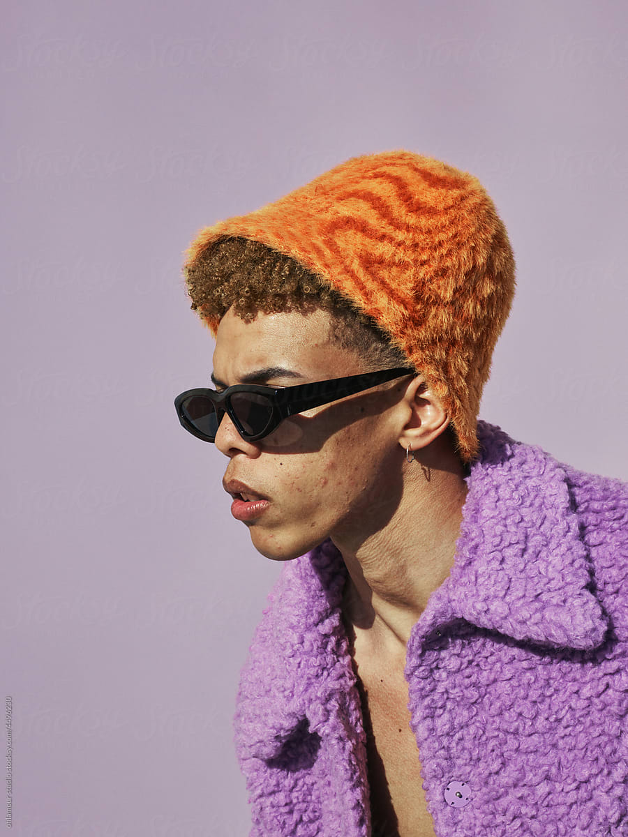 Furry orange hat with expressive face and sunglasses - daylight