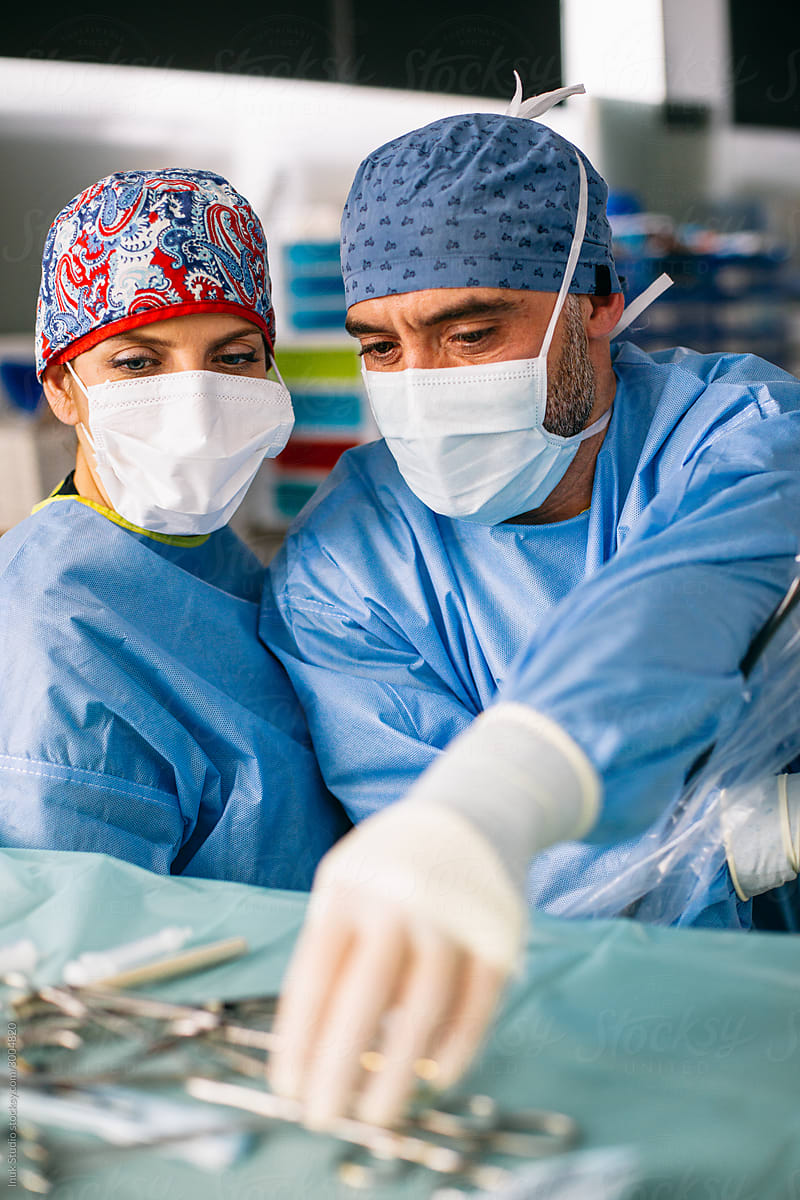 Surgeon and assistant in operating theater