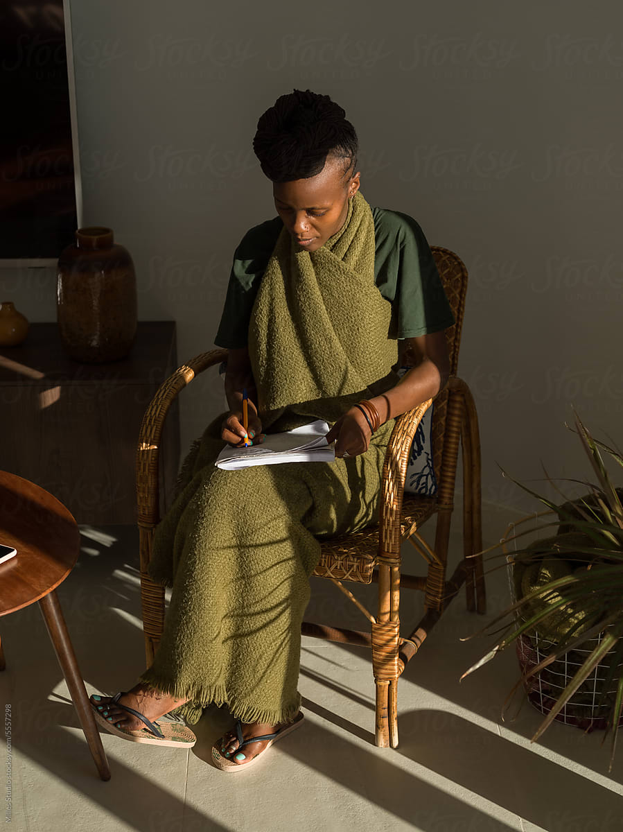 Black female student preparing task in lounge