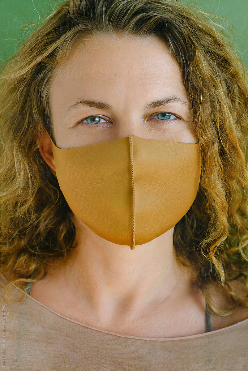 Curly girl in a protective mask from textiles.