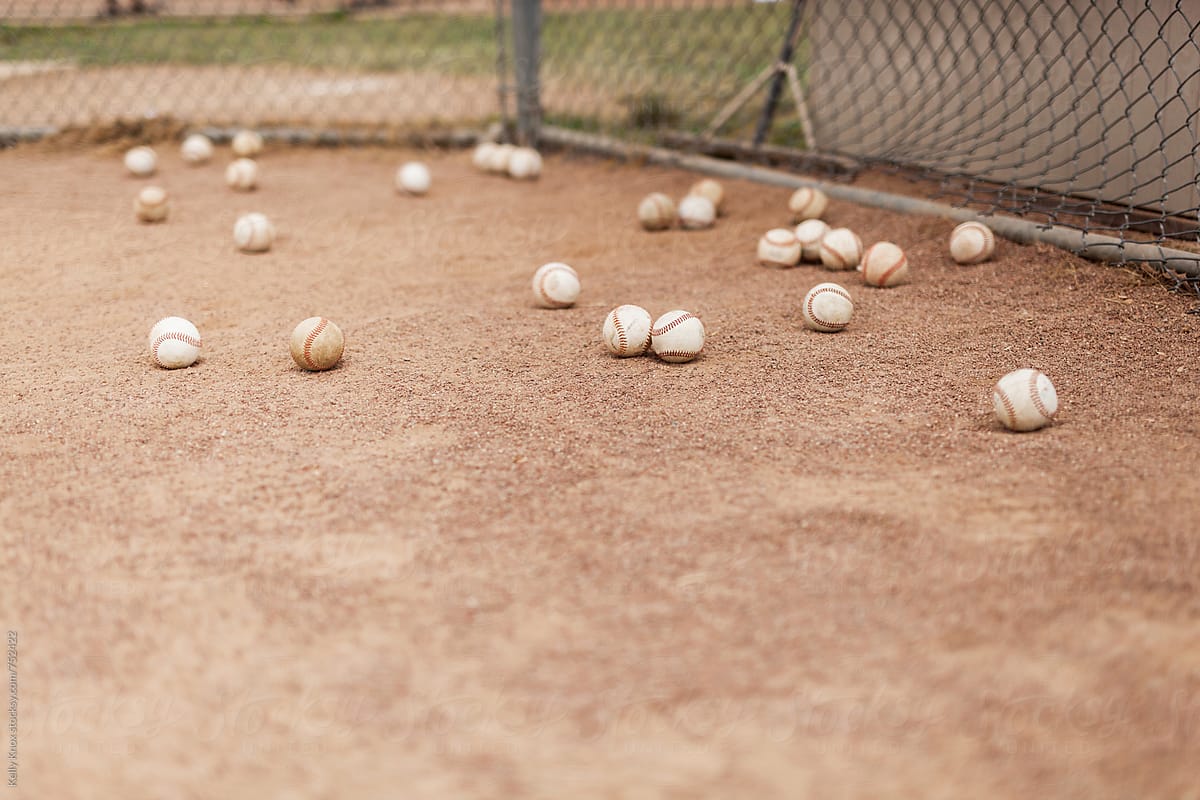 baseballs behind home plate during batting practice