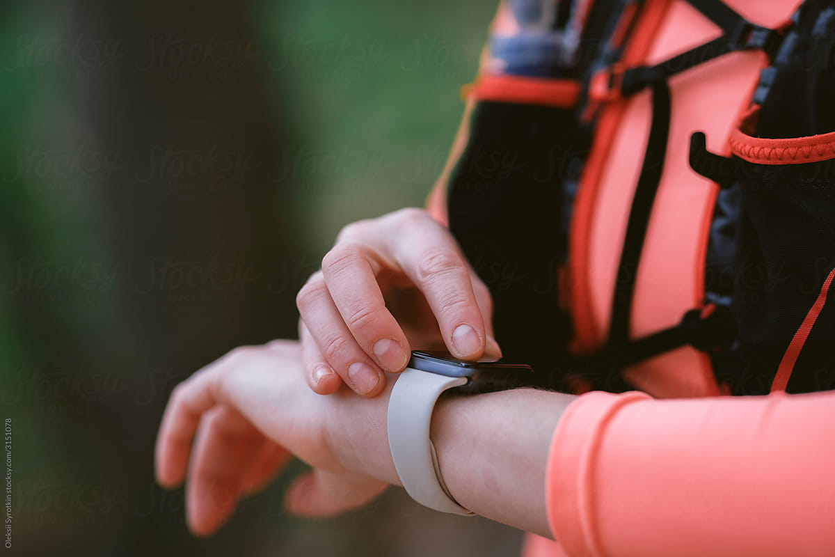 Runner using smartwatch during jogging