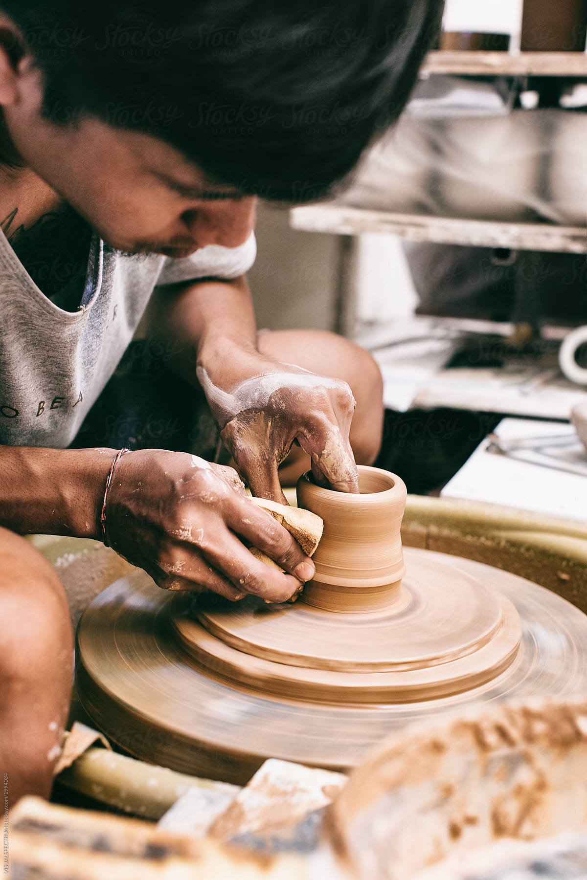 Closeup of Young Male Potter Working on Vase