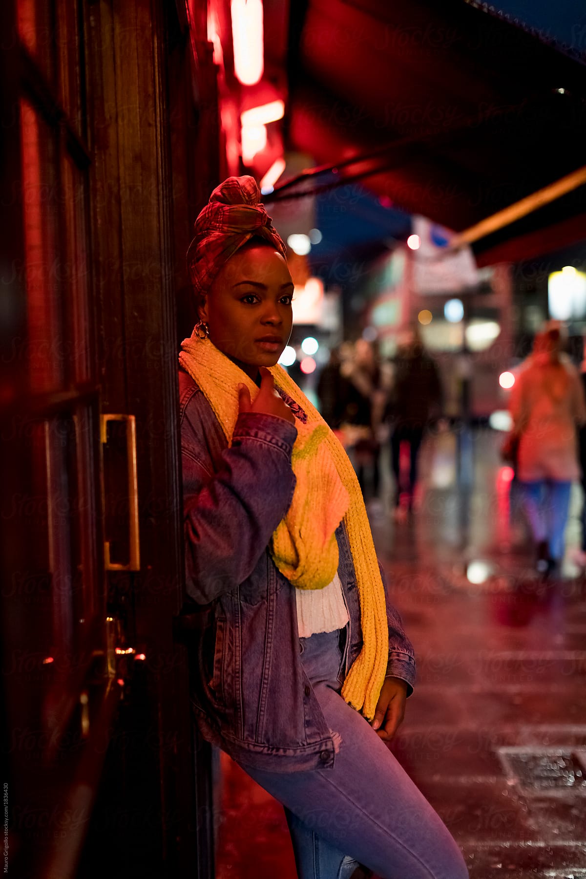 Black woman waiting for her friend out of a pub