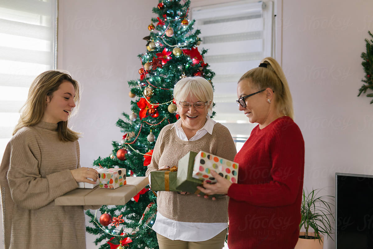 Caucasian family giving away Christmas presents at home