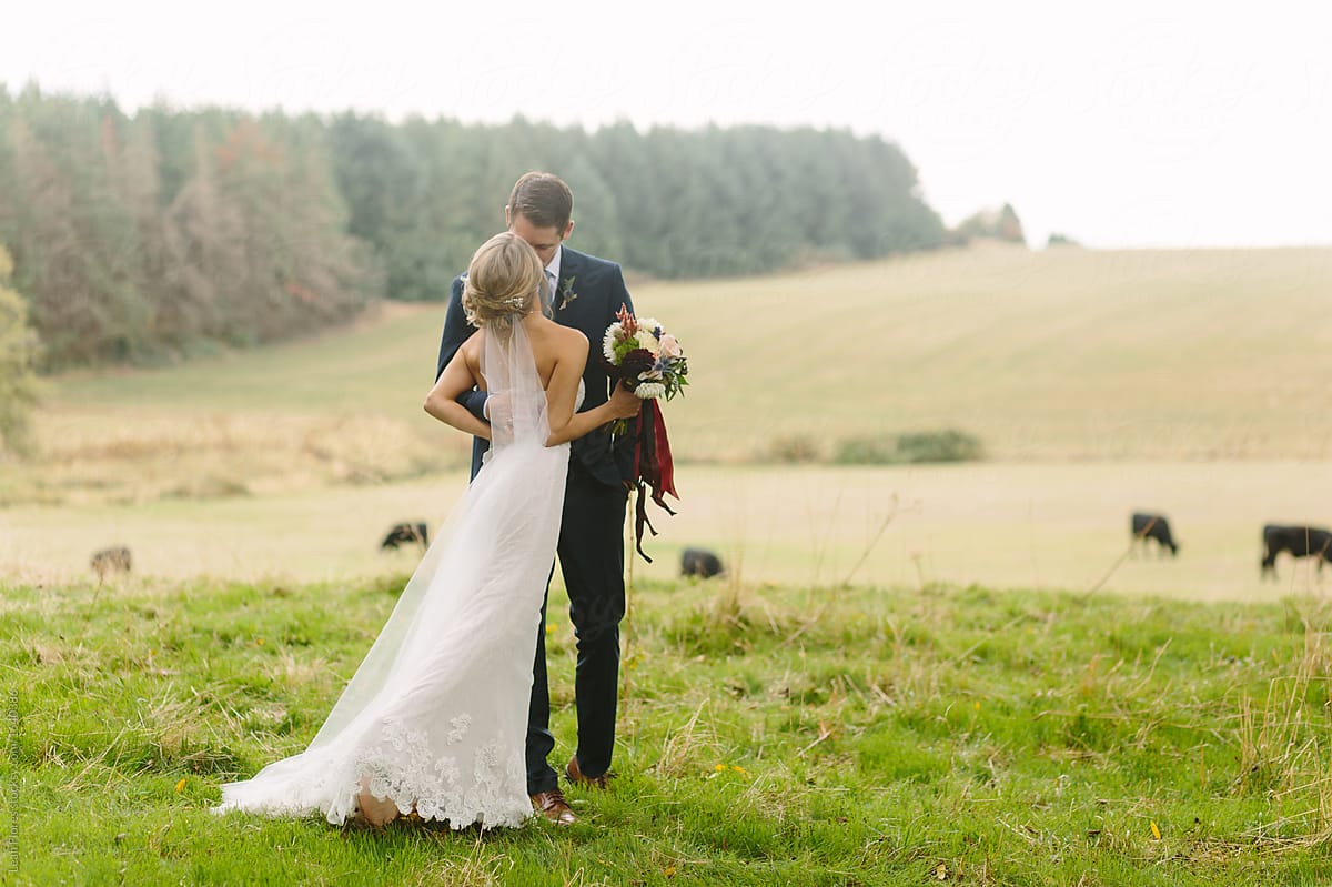 Couple Kissing on Hill Overlooking Farm